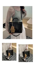 Minimalist retro women black PU leather bucket shoulder crossbody bag with cute bear charm.