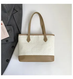 Detailed view of women fashion woven tote bag, elegant white and brown leather design.