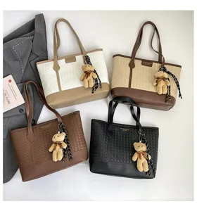 Stylish women woven tote bag large capacity casual shoulder bag with cute bear pendant for daily use.