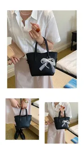 Detailed view of black bucket bag featuring elegant white lace pearl bow and textured PU leather.