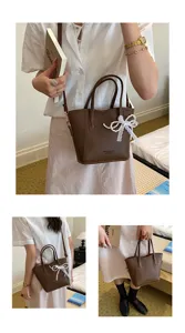 Premium bucket bag for women, stylish brown leather handbag with elegant pearl bow detail.