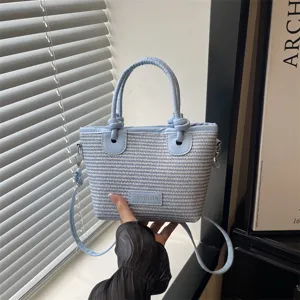 Stylish light blue woven bucket bag with knot handle and shoulder strap for daily summer use.