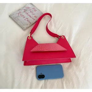 Pink crocodile pattern crossbody bag, unique geometric shape, stylish shoulder handbag for women.