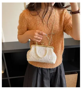Exquisite vintage lace kiss-lock handbag with pearl handle and chain strap for elegant evening wear.