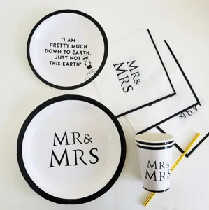 Black and white party tableware set including paper plates, cups and napkins for wedding.