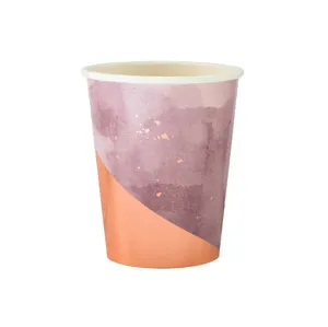 Detailed close-up of a disposable paper cup featuring pink watercolor and rose gold foil design.