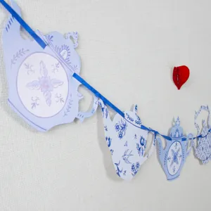 Blue and white porcelain teapot paper garland for party decoration and festive venue setup.