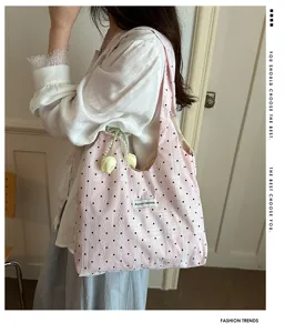 Detailed view of pink polka dot lace tote bag, casual underarm shoulder bag for daily wear.