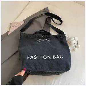 Casual denim canvas shoulder bag with crossbody strap and large capacity for daily student use.
