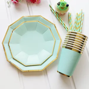 Mint green and gold party tableware set with decagonal plates cups and striped straws.
