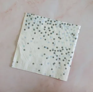 Disposable paper napkin with blue and grey dots for party table decoration and events.