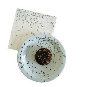 Disposable light blue paper plates and napkins set with silver foil dots for party celebrations