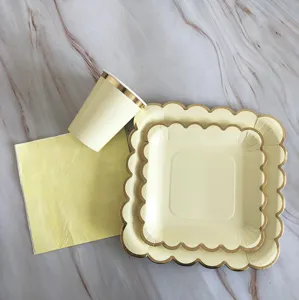 Elegant disposable paper plates cups and napkins set with gold foil edge for birthday party decor.