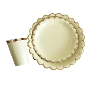 Disposable paper plates and cups set with gold foil scalloped edge for party birthday decor.