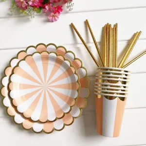 Scalloped edge peach and white striped paper plates cups and gold straws set for party tableware.