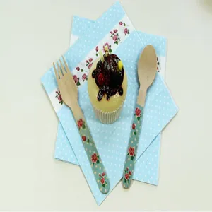 Children birthday party decoration colorful printed paper napkins with rose theme and wooden cutlery.