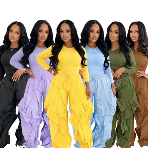 Detail view of women two piece set long sleeve top and ruffle wide leg pants in multi colors.