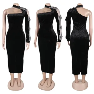 Details of the black velvet one-shoulder dress showing sheer sleeve and rhinestone bows.