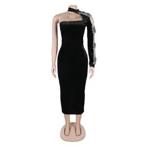Detail view of the black velvet one-shoulder bodycon dress with sheer sleeve and rhinestones.