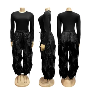 Detailed view of black long sleeve top and gathered drawstring trousers two piece set details.