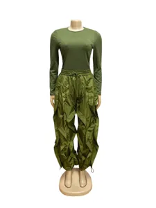 Olive green two-piece outfit featuring a slim long-sleeve top and ruffled wide-leg pants.