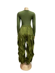 Back view of unique olive green two-piece outfit featuring ruffles and pleated wide-leg pants.