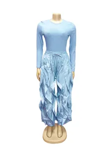 Detail view of women's light blue long sleeve slim top and ruffled wide leg pants outfit.