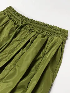 Green women's casual trousers elastic high waist drawstring detail close-up comfortable soft fabric