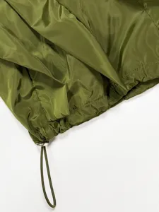 Olive green women apparel detail view with adjustable drawstring hem and metal lock.