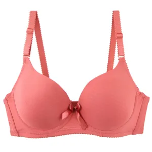 Seamless push-up bra detail showing smooth fabric, adjustable straps and delicate bow decoration.