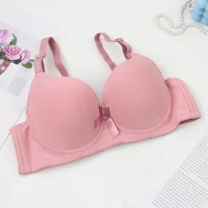 Detailed shot of a pink seamless push-up bra, showing smooth fabric and cute bow.