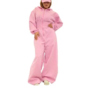 Detailed shot of casual pink hooded jumpsuit, long sleeves, front zipper, wide leg style.
