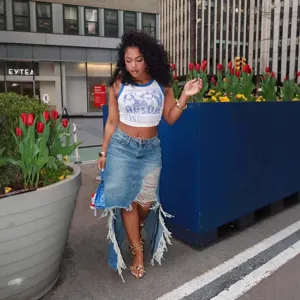 Street style distressed denim skirt with irregular hem and raw edges, stylish chic apparel.