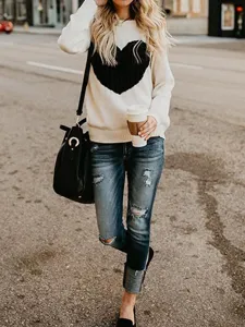 Lässiger, lockerer Damen Strickpullover mit schwarzem Herz Muster und langen Ärmeln.