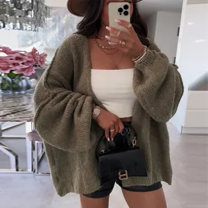 Women's oversized V-neck solid color knit cardigan sweater, casual autumn outerwear detail view.