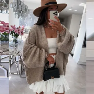 Detail view of women's casual loose knit cardigan sweater in solid khaki, cozy daily wear.