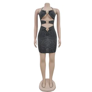 Black halter mini dress detail featuring heavy rhinestones, metal rings, and sexy cut-out design.