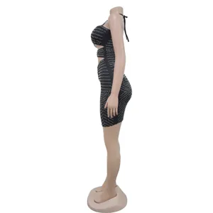 Side detail view of a black rhinestone cutout halter bodycon mini dress for party wear.