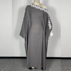 Detail view of dark grey long dress with elegant white lace trim on the oblique collar.