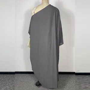 Close-up detail shot of grey one-shoulder long sleeve dress showing texture and design.