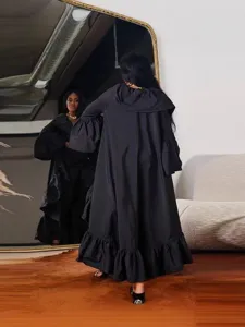 Black long hooded cape coat for women, elegant ruffle hem outerwear for street fashion.