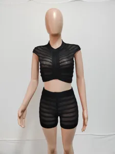 Close-up detail view of the black knit crop top and high waist shorts two piece set texture.