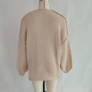 Back detail view of casual loose solid pink knit sweater for women autumn winter daily wear.