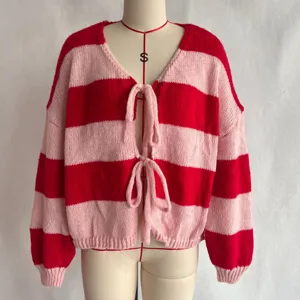 Close-up detail of the red pink striped knit cardigan, showcasing tie-front design and texture.