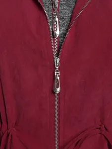Close-up detail of women windbreaker double zipper grey inner layer wine red fabric