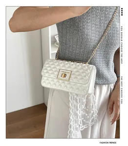 Elegant quilted chain shoulder bag with metal lock and textured PU leather design detail.