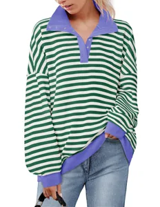 Close-up detail of green and white striped oversized sweatshirt with purple lapel and cuffs.