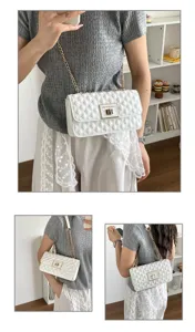 Detailed view of white quilted chain shoulder bag with elegant metal clasp and strap.