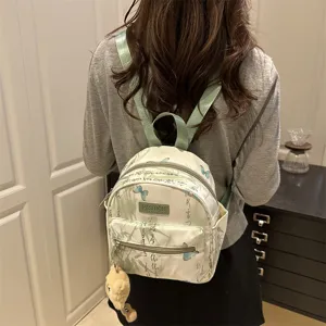 Mini butterfly print canvas backpack for women, casual vintage school bag with cute pendant.