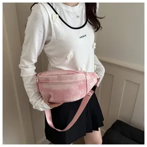 Pink checkered crossbody bag detail showing canvas texture, smooth zipper, and adjustable strap.
